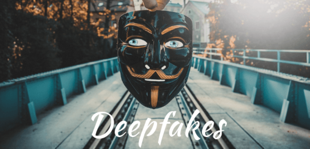 maske wird ins bild gehalten, dahinter ist ein bahngleis zu sehen. Schrift: Deekfakes